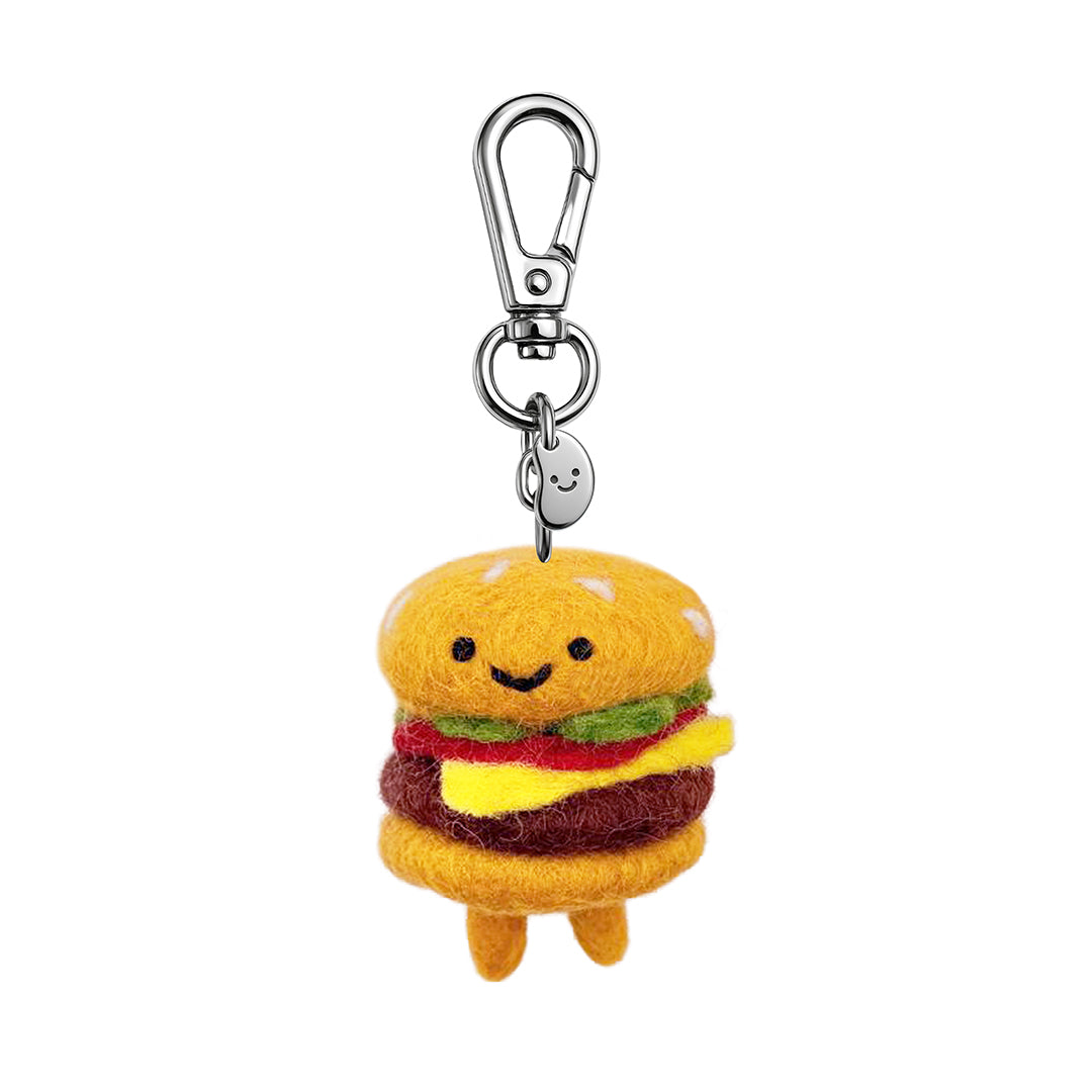 Felt burger keychain with smiling face, yellow top bun, green lettuce, and metal clip