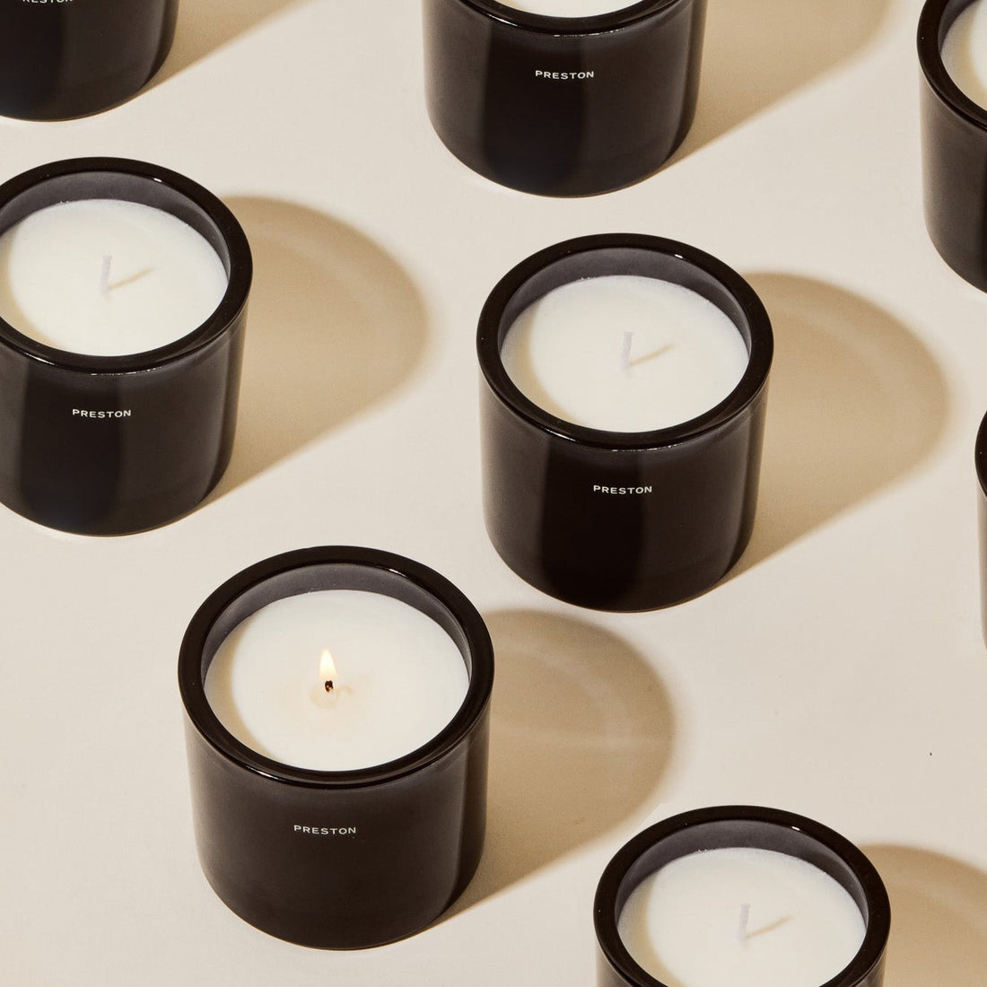 7oz candle in dark glass jar, white wax with centered wick, Preston logo on front
